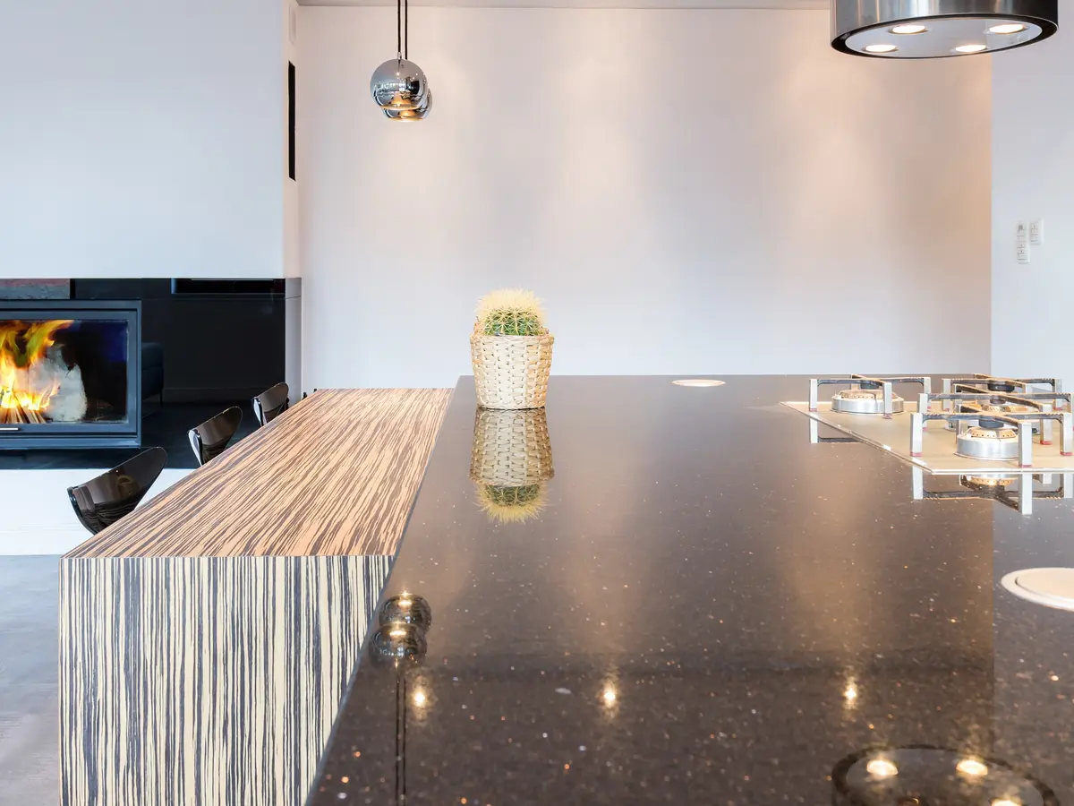 Black quartz countertop in an open kitchen