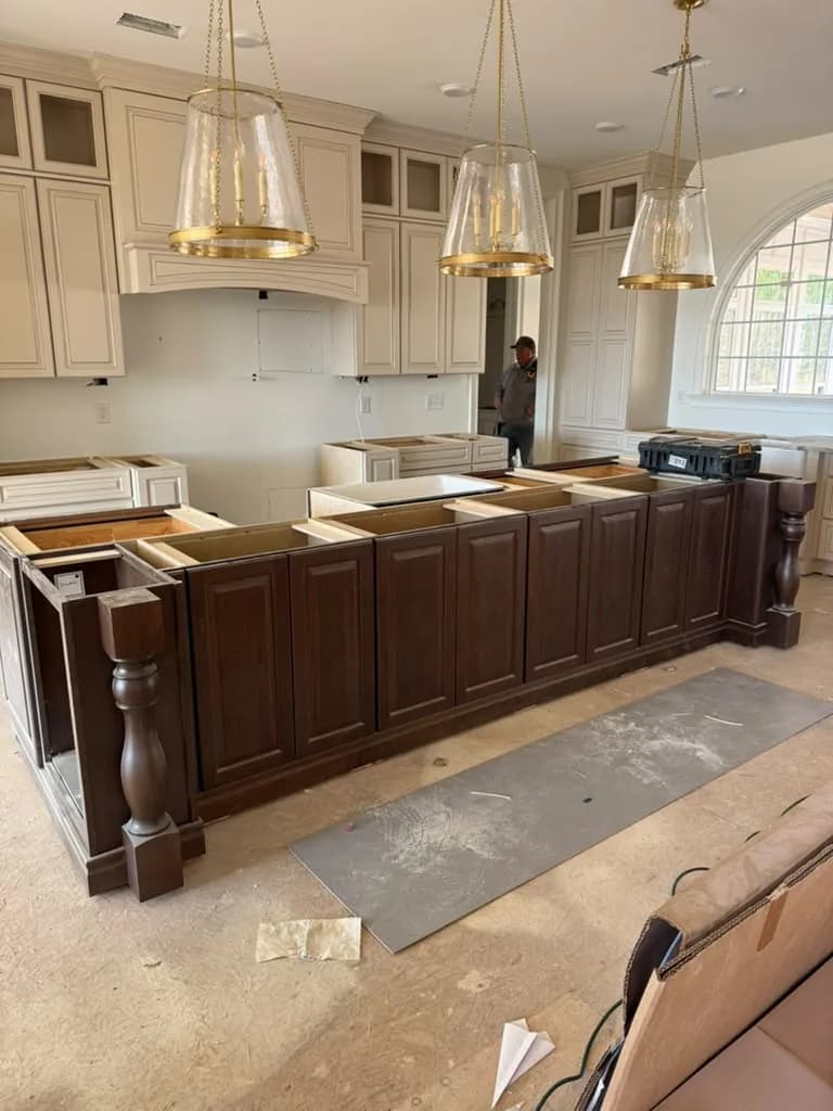 Kitchen with a dark island and white stone countertops installed by Easy Countertops near Marietta